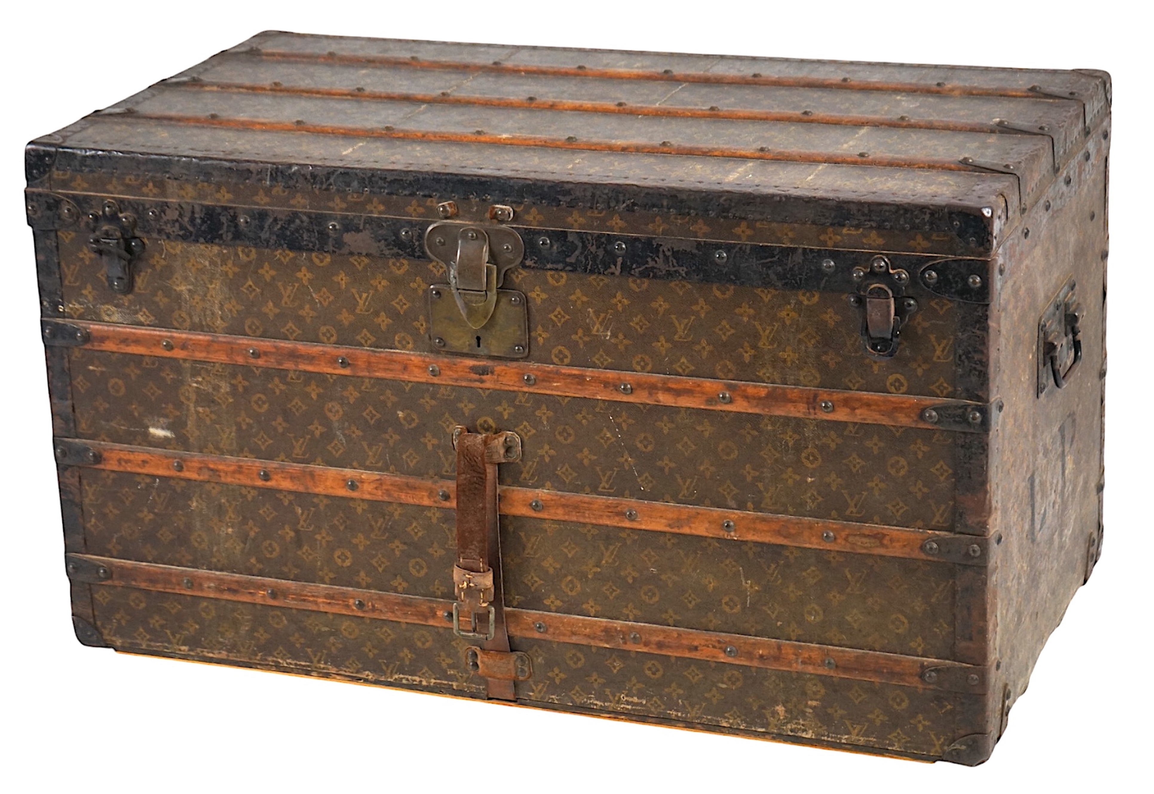 A vintage Louis Vuitton trunk, with wooden slats and black painted steel bound LV canvas, label for Paris, Nice, Lille and London, and numbered stamp 212361, with two internal canvas trays, 100cm wide, 54cm deep, 58cm hi